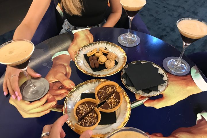 a woman sitting at a table with a plate of food