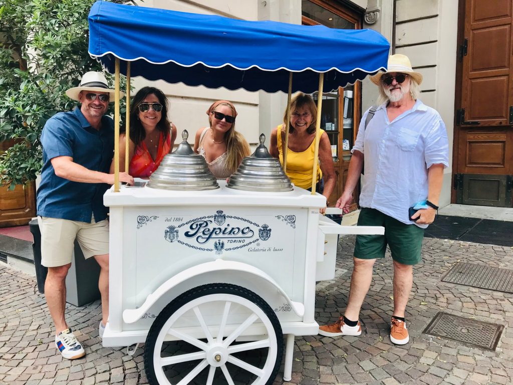 a group of people standing in front of a car