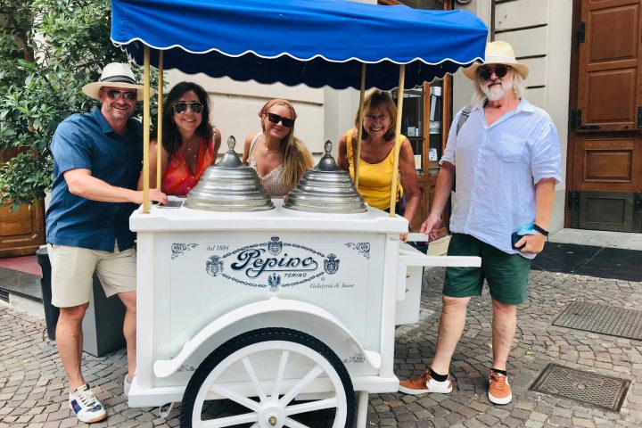 a group of people standing in front of a car