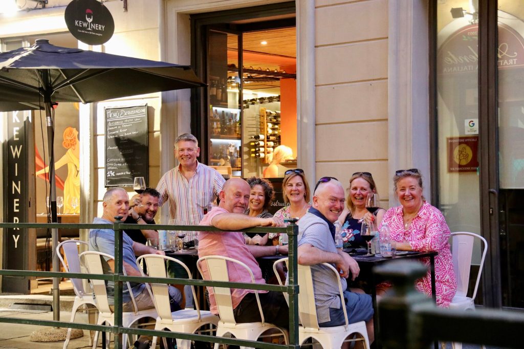 a group of people sitting in front of a store