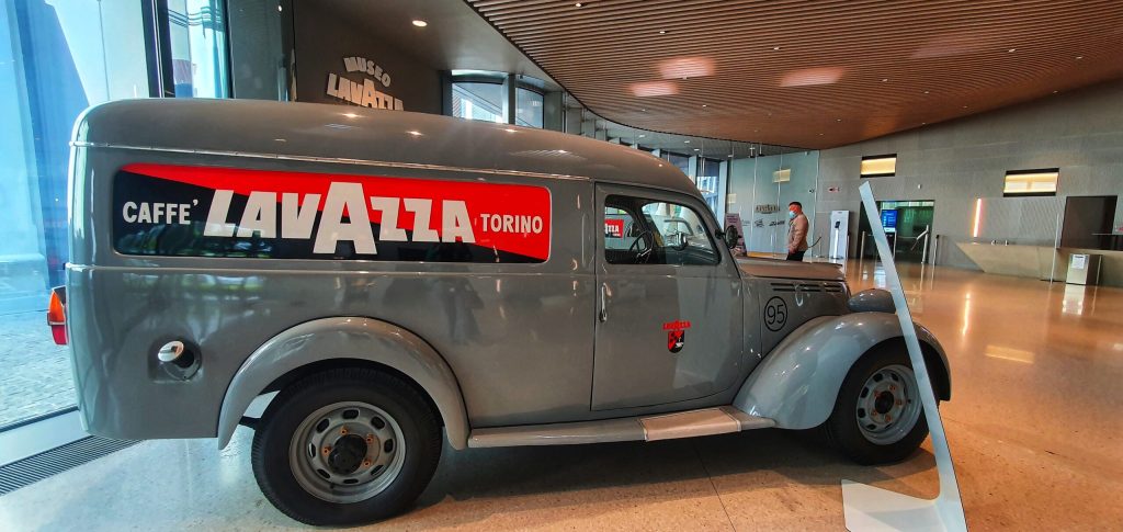 a car parked in front of a truck
