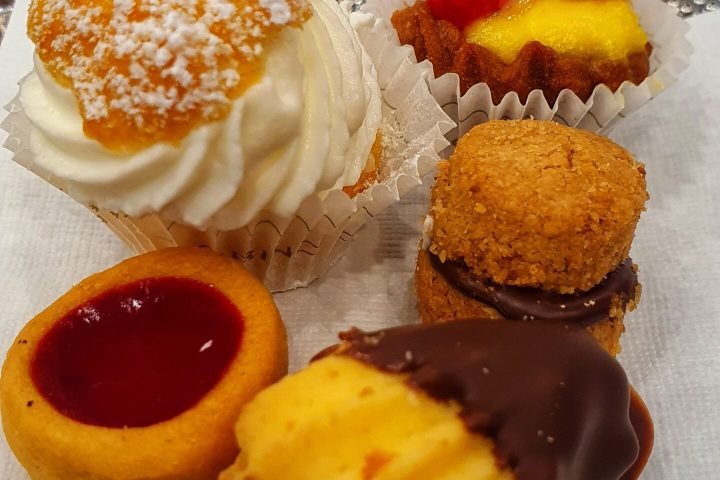 a piece of cake on a plate next to a cup of coffee