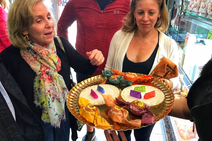 a woman standing in front of a group of people posing for the camera