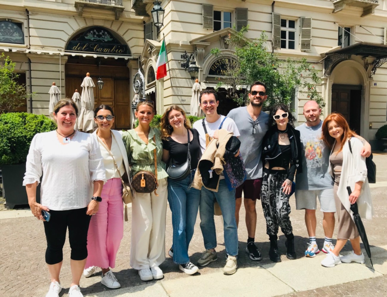 a group of tourists standing in front of Del Cambio