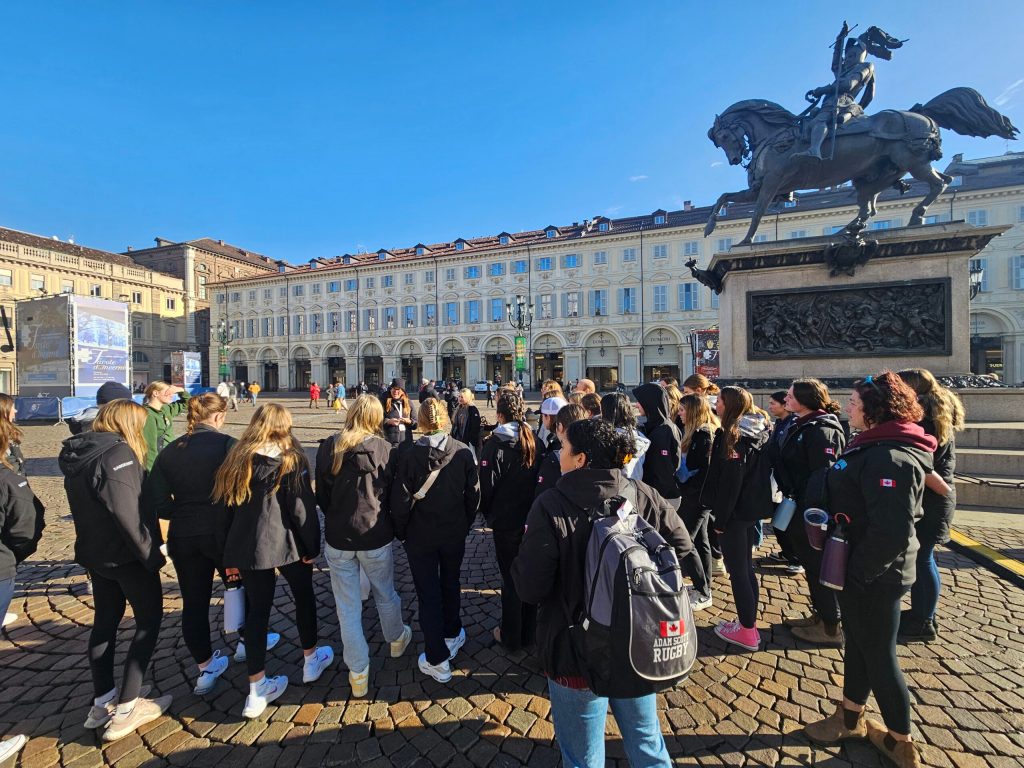 a group of people standing in front of a crowd posing for the camera