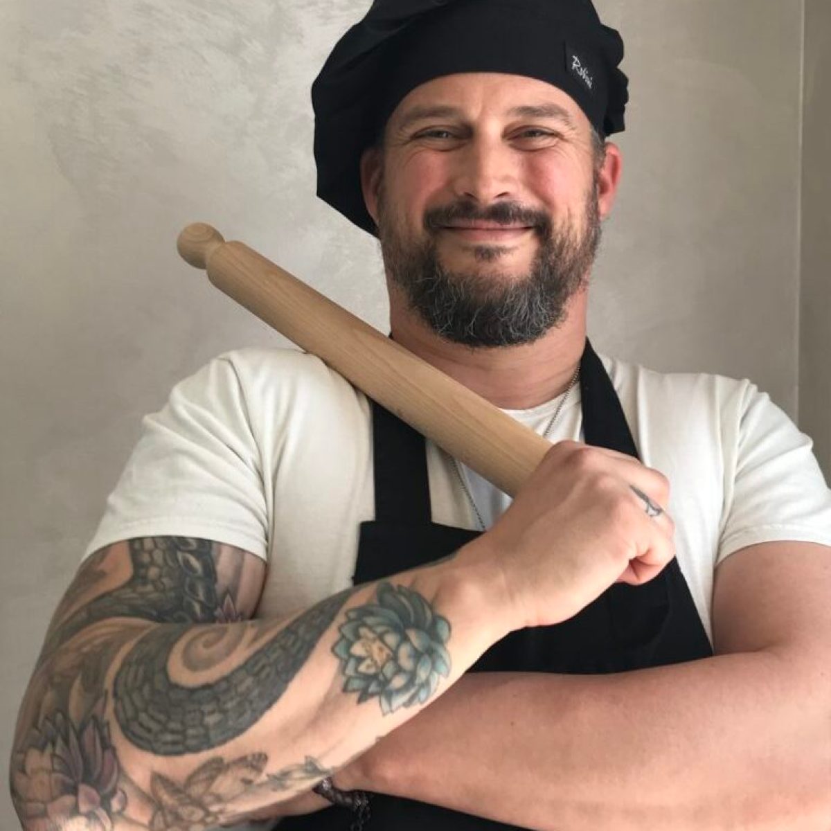 a chef holding a baseball bat