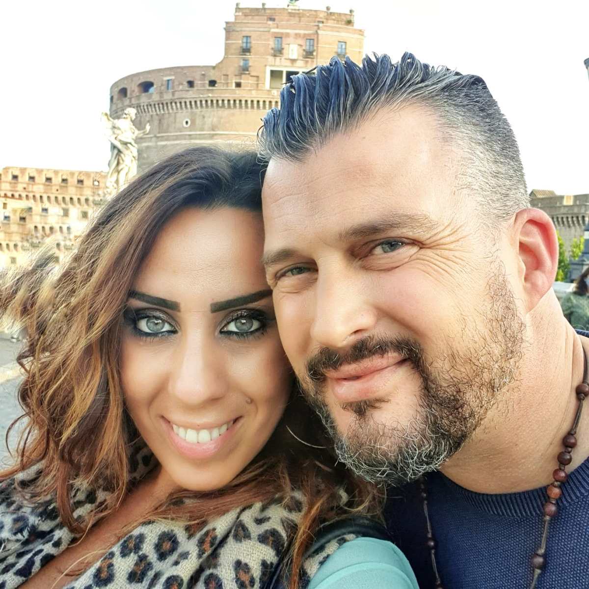 ad9c2e30-f5df-48b7-a296-52724bdb064c a close up of a man and a woman smiling for the camera