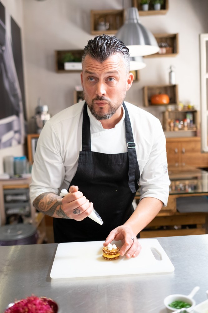 a person cutting a cake