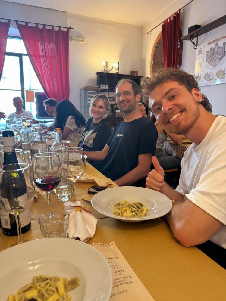 a group of people sitting at a table eating food