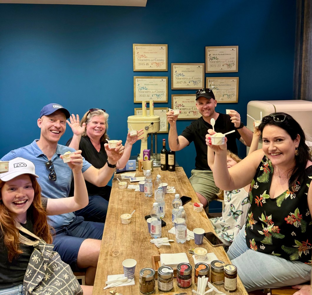 a group of people sitting at a table posing for the camera