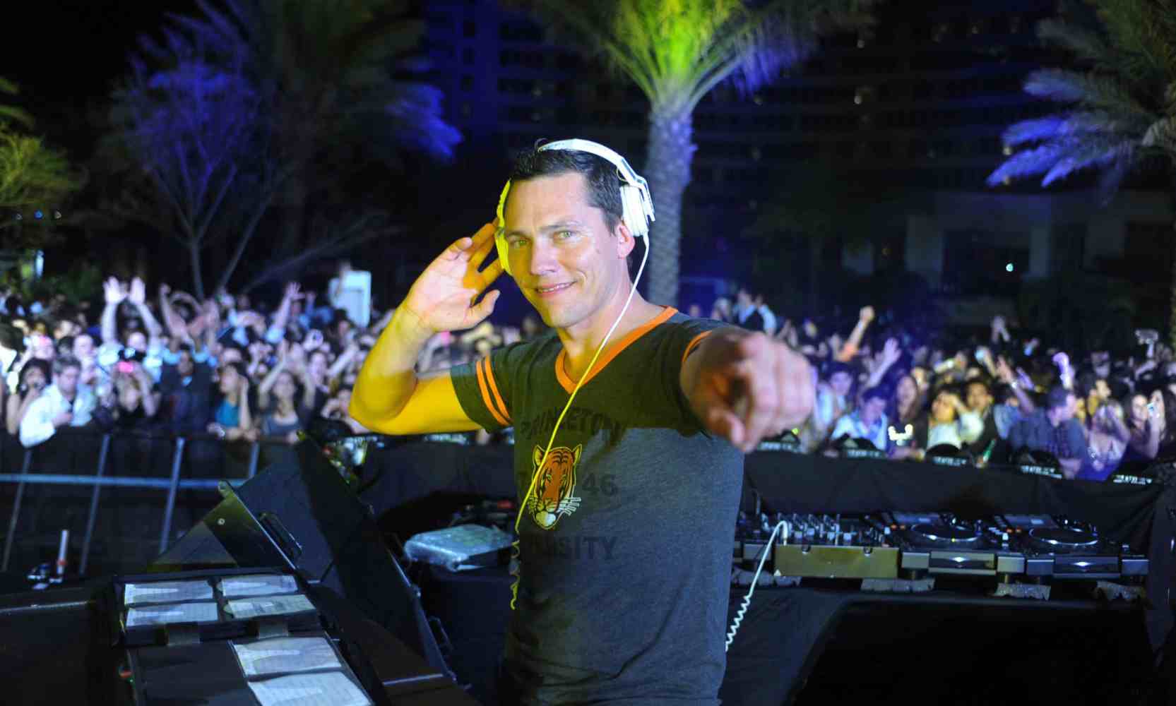 Tiesto standing in front of a stage