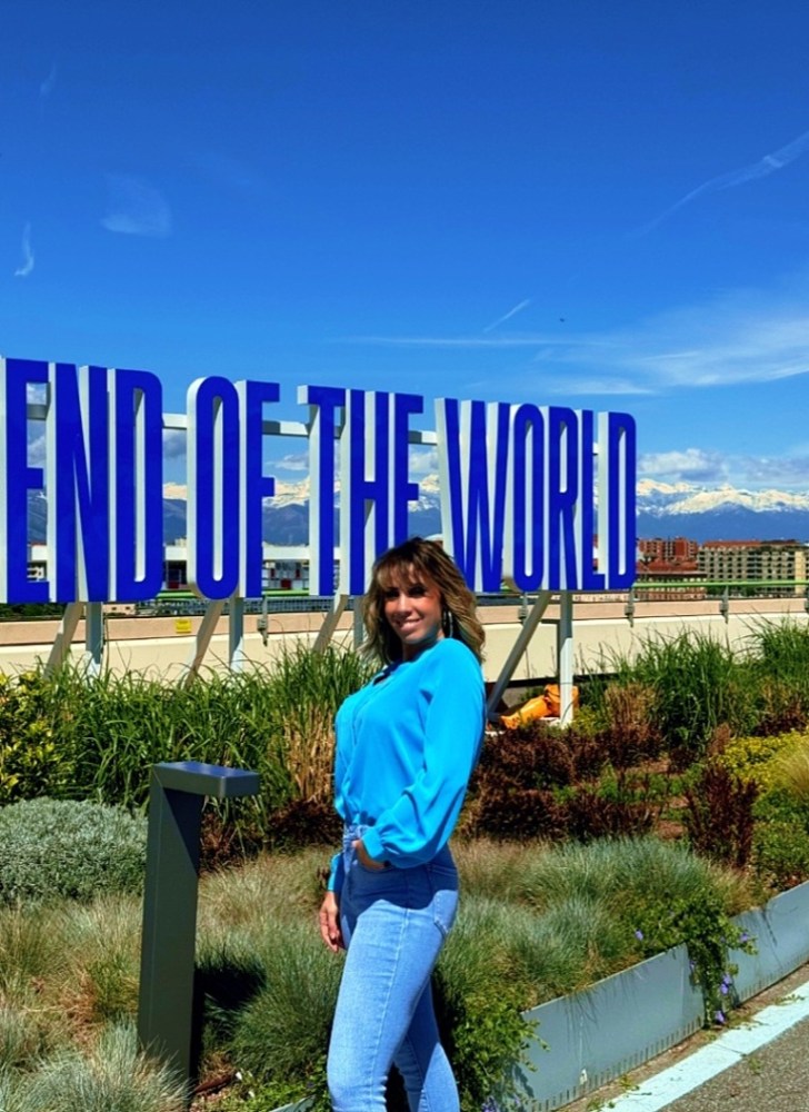 a person standing in front of a blue bench