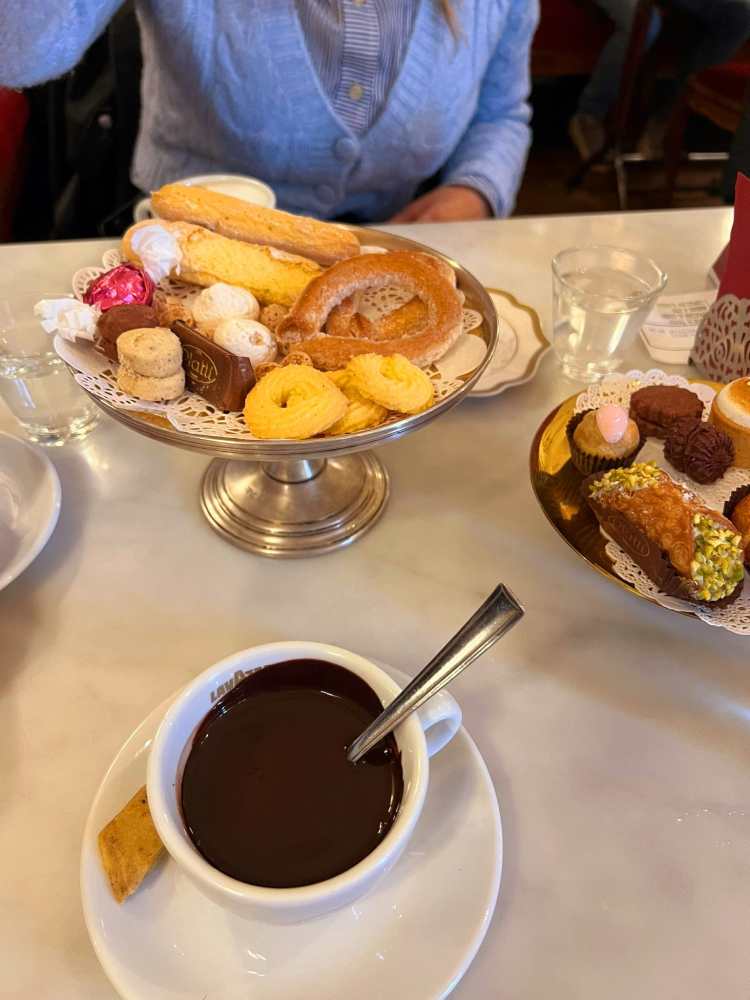 a plate of food and a cup of coffee on a table