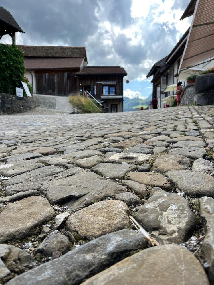 a stone building that has a rocky cliff