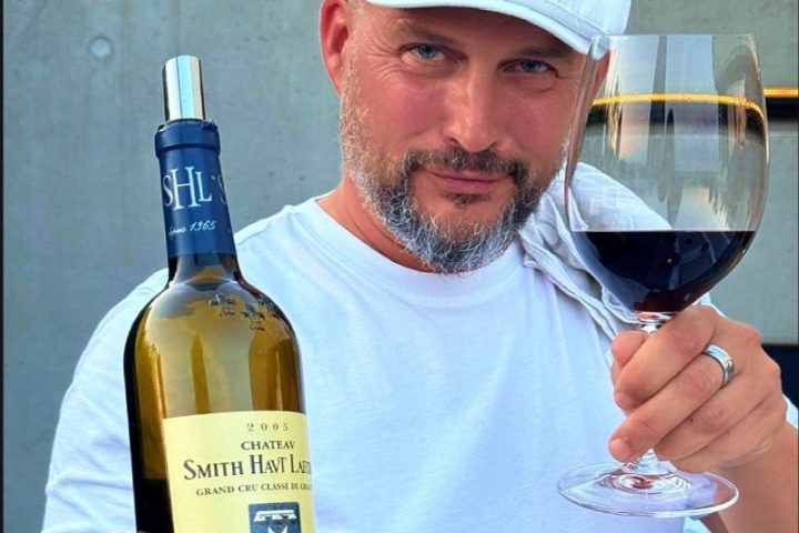 a man holding a glass of wine