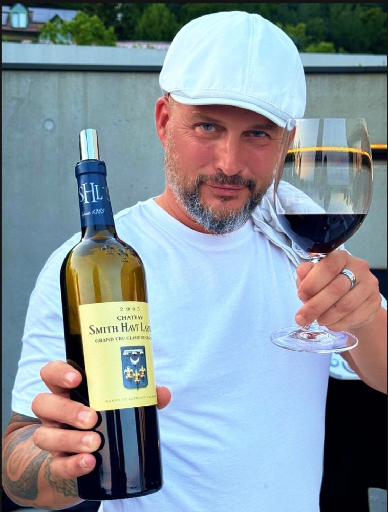 a man holding a glass of wine