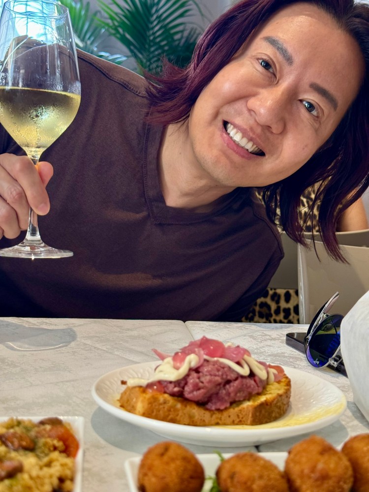 a woman sitting at a table with a plate of food