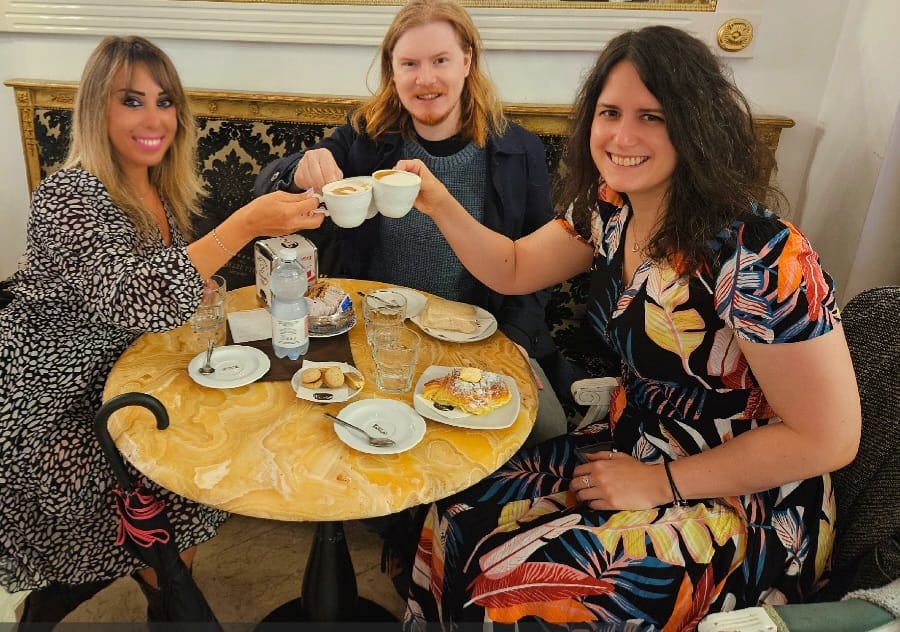 a group of people sitting at a table eating food