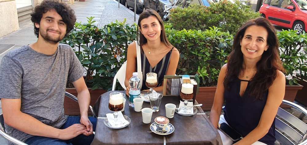 a group of people sitting at a table posing for the camera