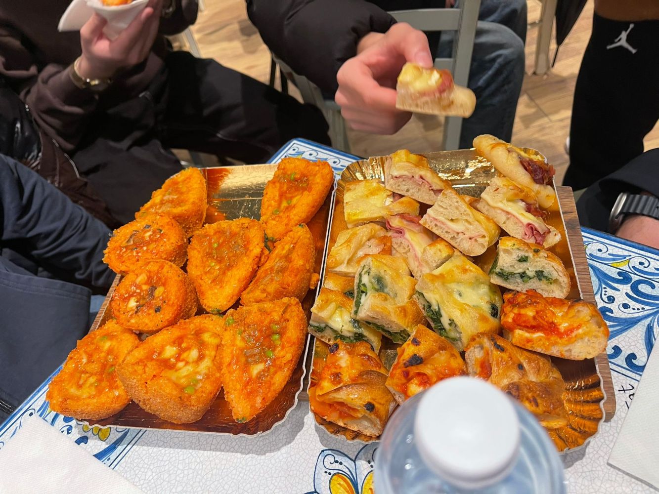 a group of people sitting at a table full of food