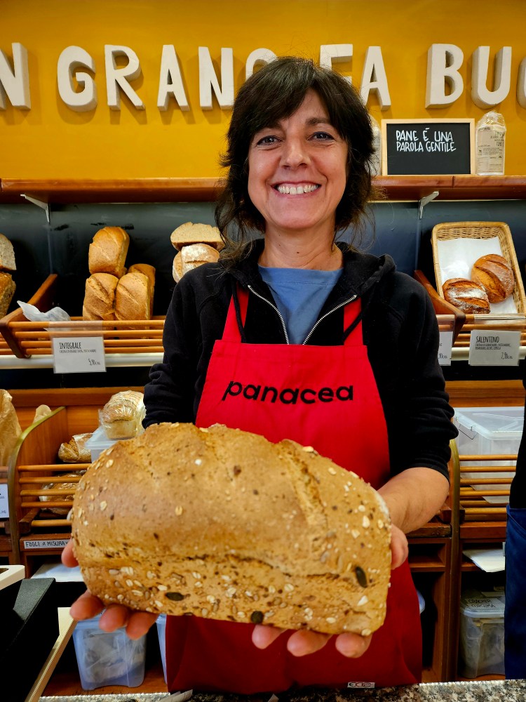 a person holding a cake in front of a store