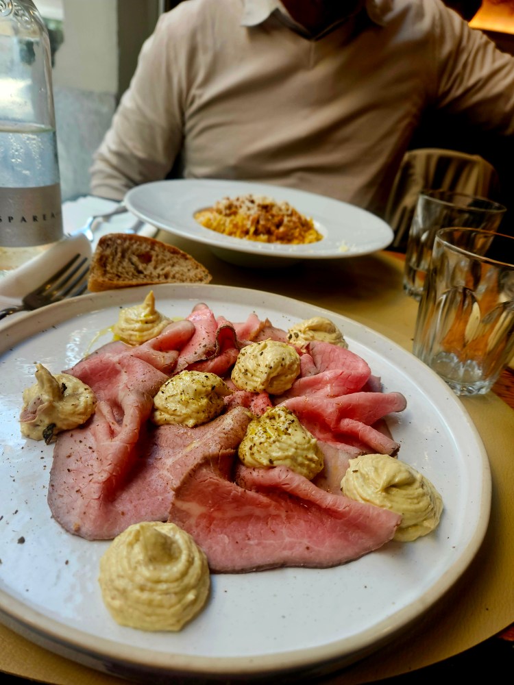 a man sitting at a table with a plate of food