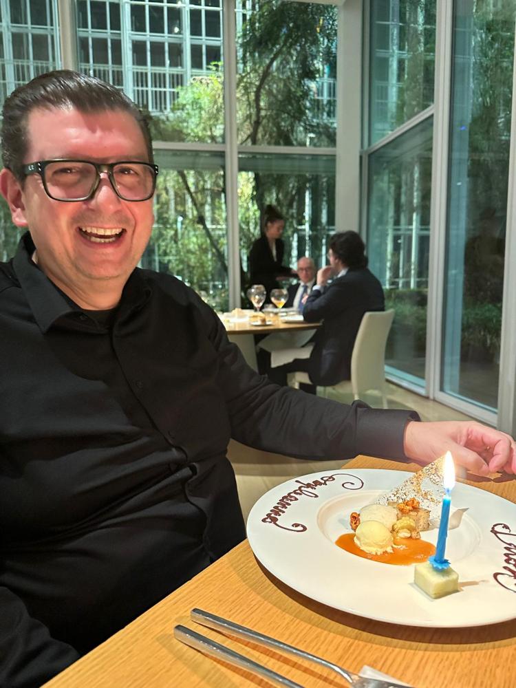 a person sitting at a table with a plate of food