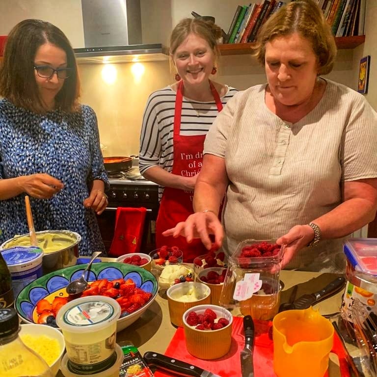 a group of people preparing food on a table