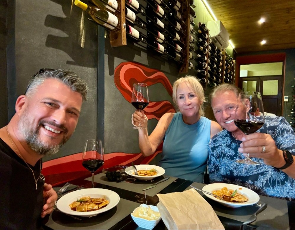 a group of people sitting at a table eating food