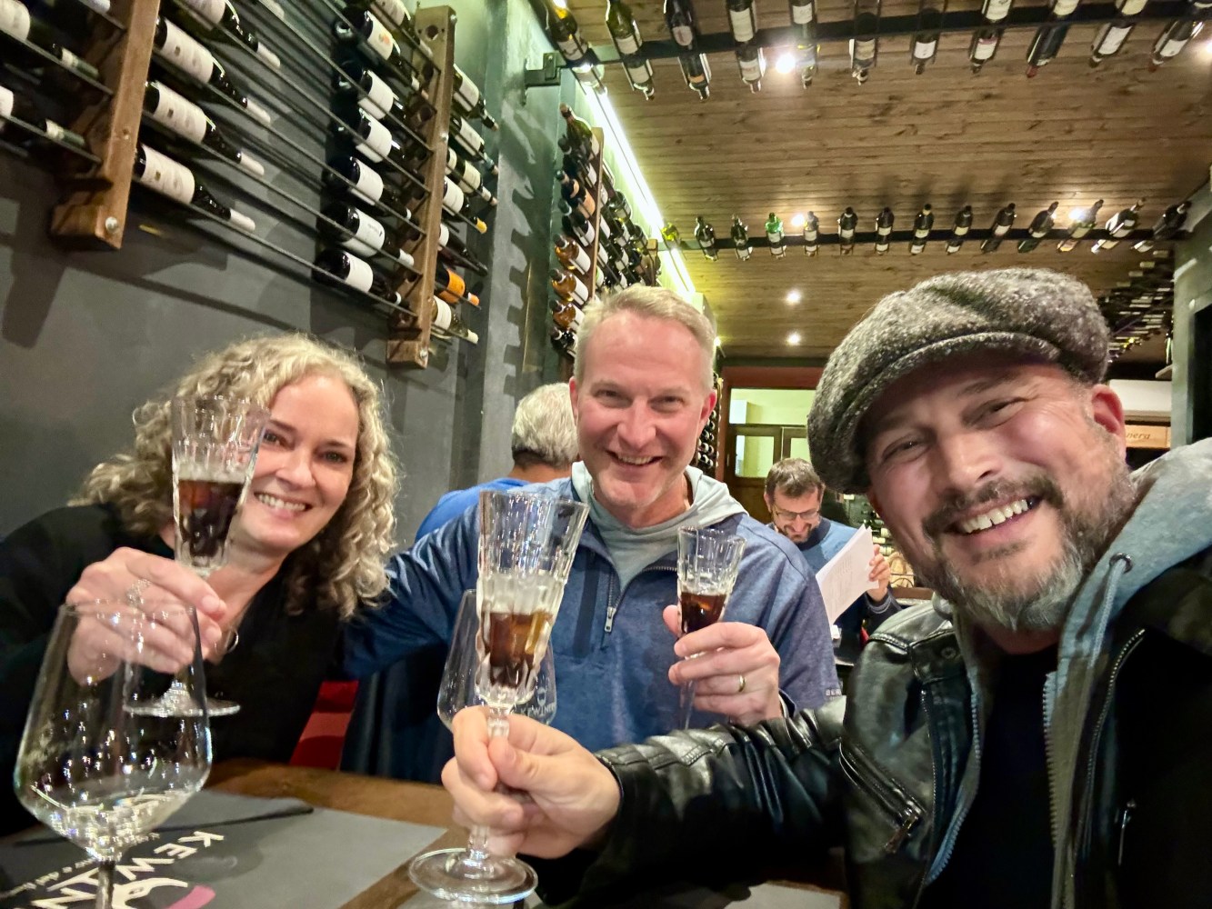 a group of people sitting at a table with wine glasses