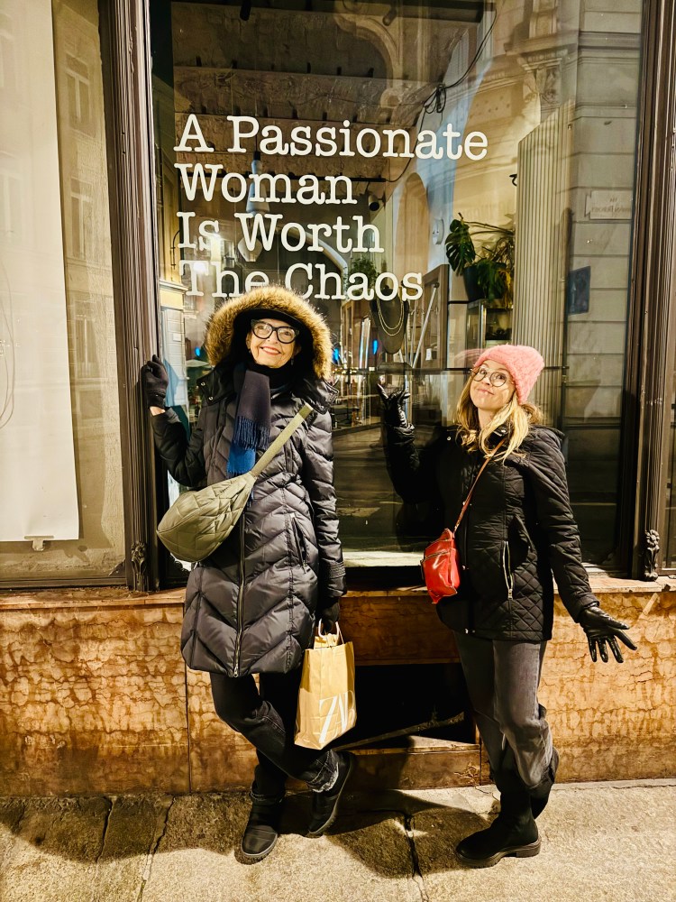 a man and a woman standing in front of a building