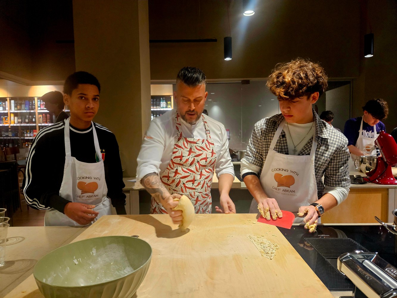 a group of people standing on top of a cutting board with a cake