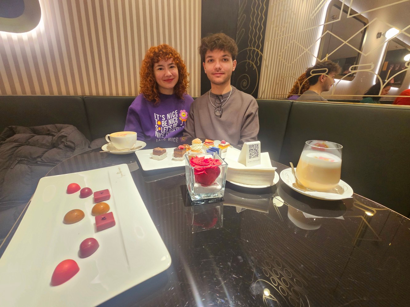 a person sitting at a table with a cake