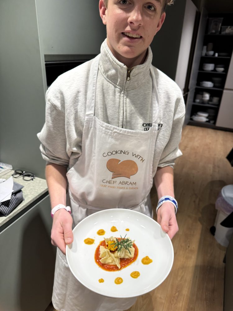 a person sitting at a table with a plate of food