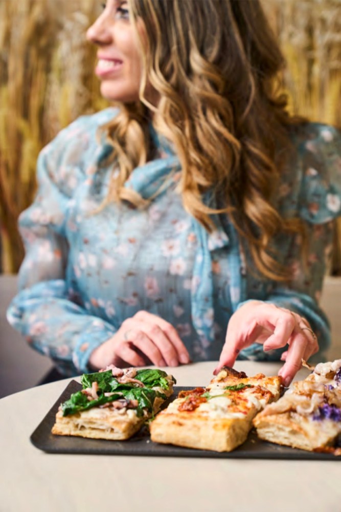a woman sitting at a table eating food